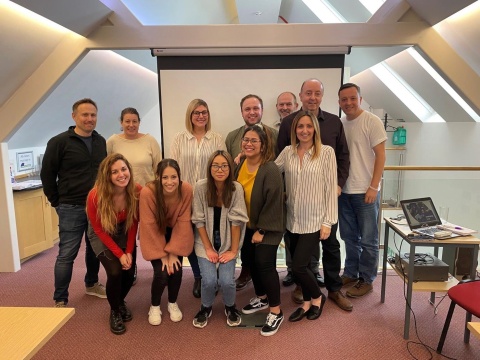 A group of people in an office posed for a photo together