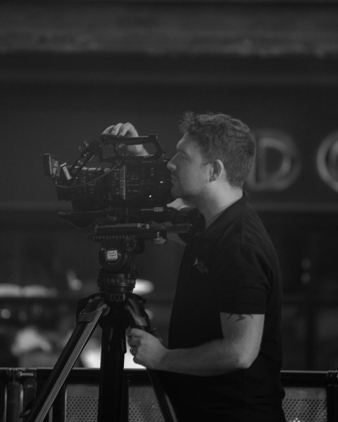 male operating a video camera