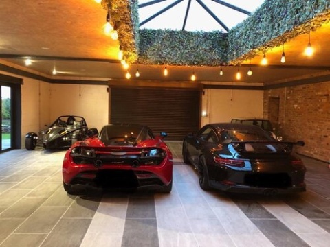 image of lighting installation above specialty racing cars, presumably in someones garage