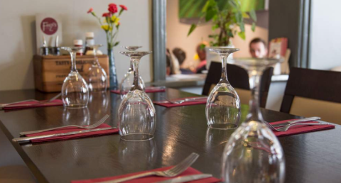 Photo at Fouzis of wine glasses on a table and cutlery
